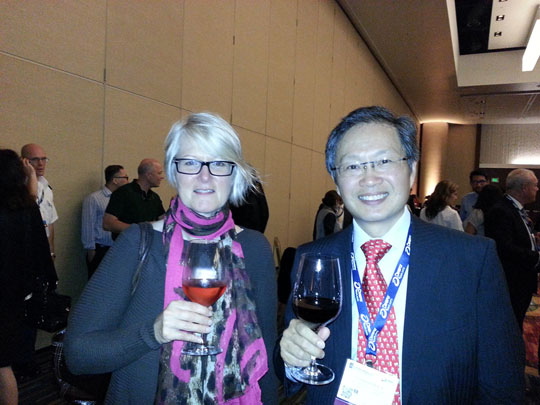 Dr Alex Chee drinking red wine at 2014 AAP